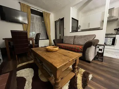 a living room with a couch and a table at The Nook Crieff - central 2-bed with garden :) in Crieff