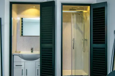 a bathroom with a shower and a sink and a mirror at Cosy & Central 2BD Apartment Milngavie, Glasgow in Milngavie