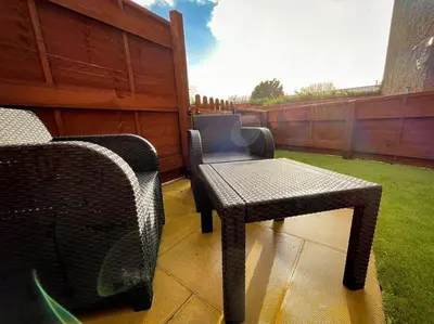 a patio with two wicker chairs and a table at The Wee Nook Crieff - 1-bed with garden :) in Crieff