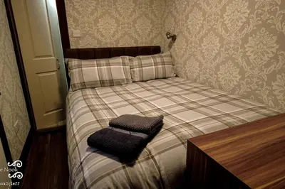 a small bed with a pillow on top of it at The Wee Nook Crieff - 1-bed with garden :) in Crieff