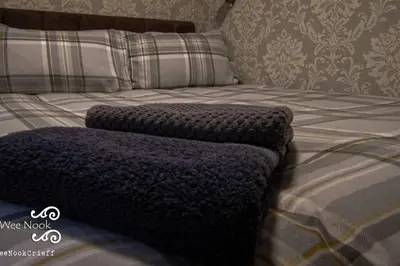 a bed with two pillows on top of it at The Wee Nook Crieff - 1-bed with garden :) in Crieff