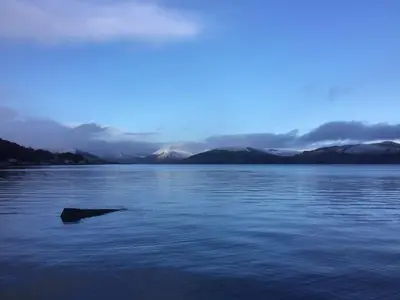 a large body of water with a rock in the water at Chapelhill Hideaway Isle of Bute licence AR00654F in Rothesay