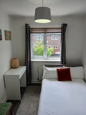 a bedroom with a white bed and a window at Urban Escape Glasgow Green Free Parking 20min walk to City Center in Glasgow