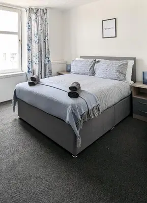 a bedroom with a bed with two hats on it at Campbeltown Loch in Campbeltown