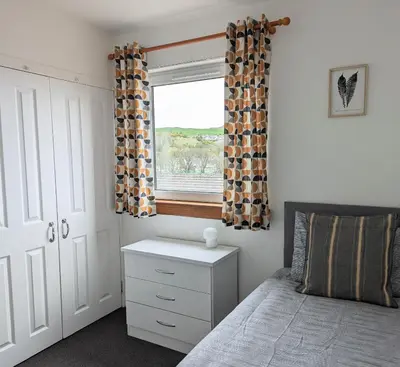 a bedroom with a bed and a window at Campbeltown Loch in Campbeltown