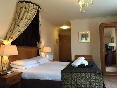a hotel room with two beds and a window at The Winnock Hotel in Drymen