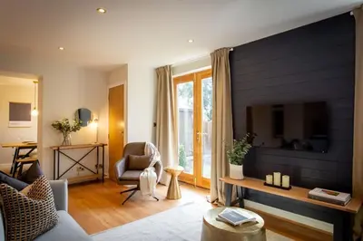 a living room with a blue accent wall at Stunning 2 bed flat with parking, and garden with mountain views in Crieff
