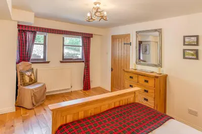 a room with a bench and a sink and window at The Old Barn - cottage with spectacular lake view in Port of Menteith