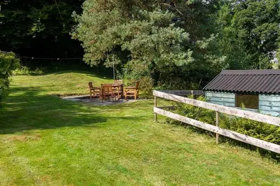 a park with a table and a wooden fence at Skerrow in New Galloway