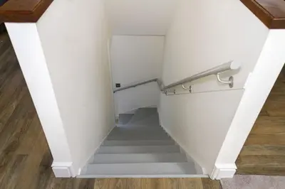 a staircase in a house with white walls and wood floors at Stroan in New Galloway