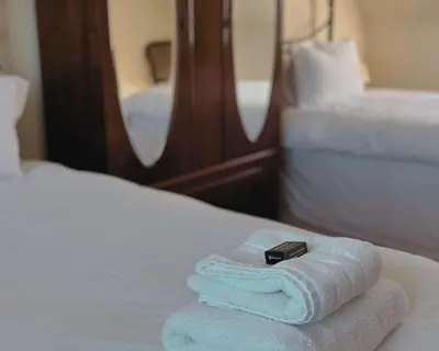 a pile of towels sitting on top of a bed at Blaeberry Cottage in Killean