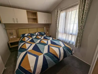 a bedroom with a bed and a window at The Castleton 20 in Ardentinny
