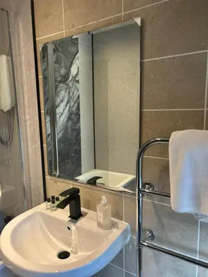 a bathroom with a sink and a mirror at Rowardennan Hotel in Rowardennan