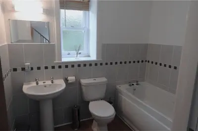 a bathroom with a sink and a toilet and a bath tub at Harebell Cottage in Killean