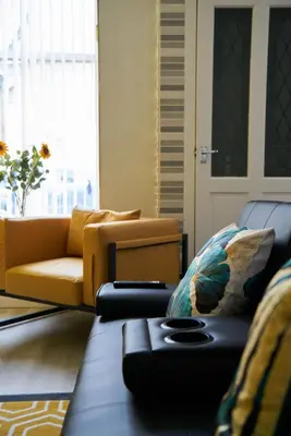 a living room with a couch and a chair at 1 BDR Apt By Caledonia Luxe Stays Short Lets & Serviced Accommodation Lanark in Douglas