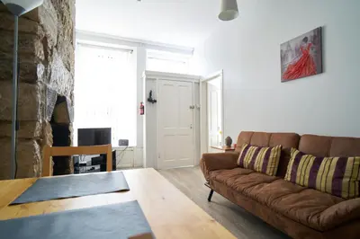 a living room with a couch and a table at 1 BDR House By Caledonia Luxe Stays Short Lets & Serviced Accommodation Lanark in Douglas