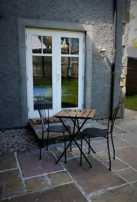 a table and two chairs in front of a window at Loch Lomond Unique Selfcontained bed+bathroom in Alexandria