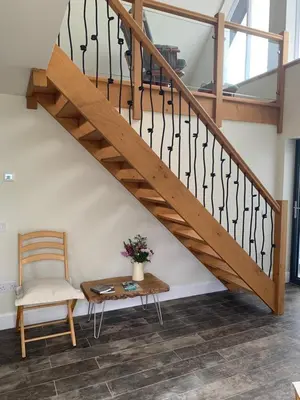 a staircase with a chair and a table at Newton Bothy in Stirling