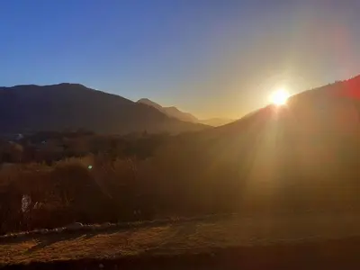 a view of the sun setting over a mountain at Highland Haven, Glencoe in Ballachulish