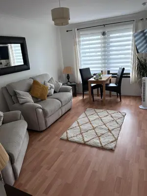 a living room with a couch and a table at Argyll Apartment Loch Lomond in Balloch