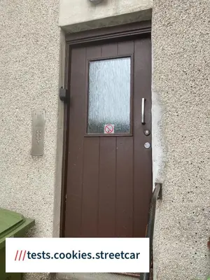 a brown door with a window on a building at Argyll Apartment Loch Lomond in Balloch