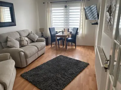 a living room with a couch and a table at Argyll Apartment Loch Lomond in Balloch