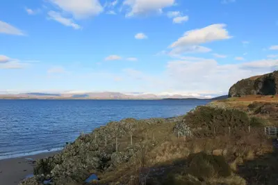 a view of the ocean from the shore of a beach at Oban Bay Hotel in Oban