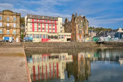 a group of buildings next to a body of water at Muthu Oban Regent Hotel in Oban