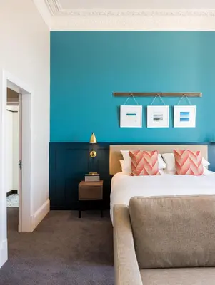 a blue room with a bed and a couch at The Perle Oban Hotel & Spa in Oban