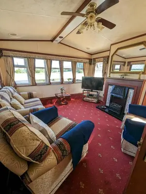 a living room with a couch and a television at The Lambourne 71 in Dunoon