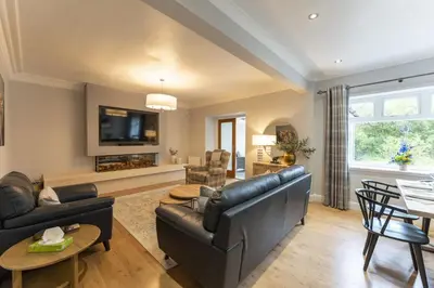 a living room with a couch and a table at The Lindsay House in Stirling