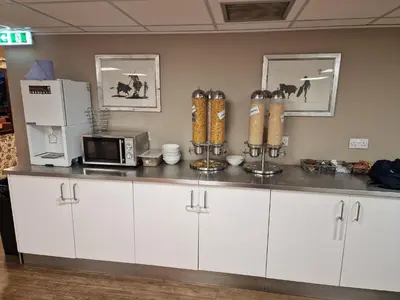 a kitchen with a counter top with a microwave at Britannia Inn Glasgow in Glasgow