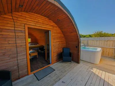 a large wooden house with a tub and a bathroom at Pond View Pod 2 with Private Hot Tub - Fife - Loch Leven - Lomond Hills in Kelty