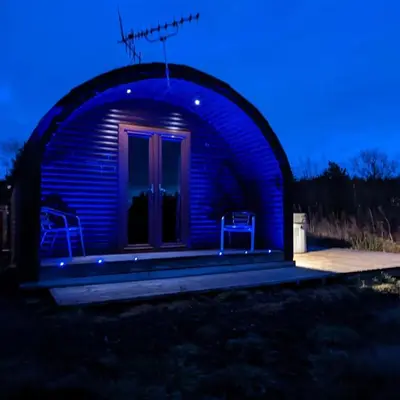 a blue lit up observatory with two chairs in it at Pond View Pod 3 With Private Hot Tub -Fife - Loch Leven - Lomond Hills in Kelty