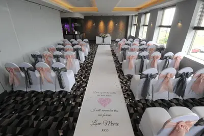 a row of chairs in a room with a aisle at Horizon Hotel in Ayr