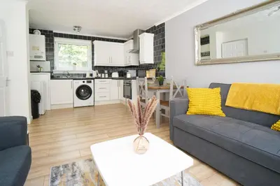 a living room with a couch and a table at Rotherwood Apartment in Glasgow