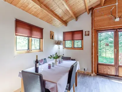 a dining room with a table with wine bottles on it at The Willows in Glencoe