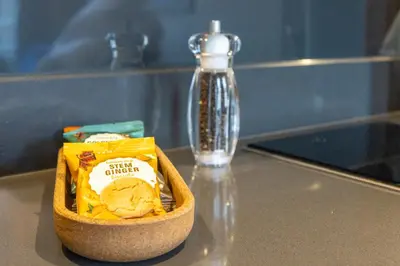 a container of food sitting on a table with a pepper at MONO Suites NEW TOWN in Edinburgh