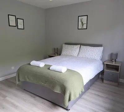 a bedroom with a bed with two towels on it at Campbeltown View in Campbeltown