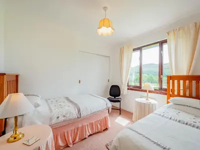 a bedroom with two beds and a window at Glenview in Appin