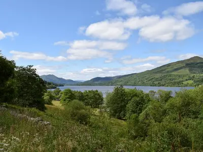 a view of a lake with mountains in the background at Stonefield Farm Cottage in Benmore