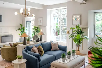 a living room with a blue couch at Grove House Hotel in Edinburgh