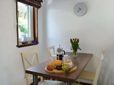 a wooden table with a plate of food on it at 15 Cairnbaan Cottage in Cairnbaan
