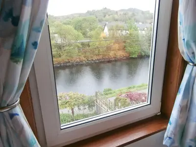 a window with a view of a river at 15 Cairnbaan Cottage in Cairnbaan