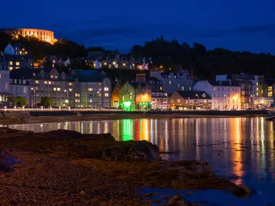 a city at night with lights on the water at Kerrera View in Oban