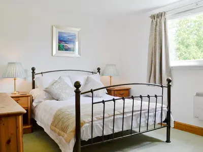 a bedroom with a bed and a window at Torsa - 28790 in Clachan