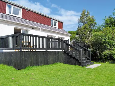 a house with a fence and a wooden deck at Torsa - 28790 in Clachan