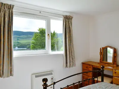 a bedroom with a window and a bed at Lunga - 28791 in Clachan