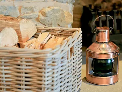 a basket with a candle next to a basket of bread at Ardbhan Croft in Oban