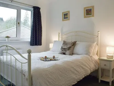 a bedroom with a bed with two toys on it at Tigh Raineach in Strathyre